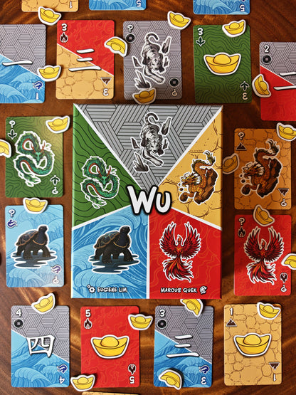 A top-down shot of Wu's box and components, featuring its vibrant card designs and gold ingots.